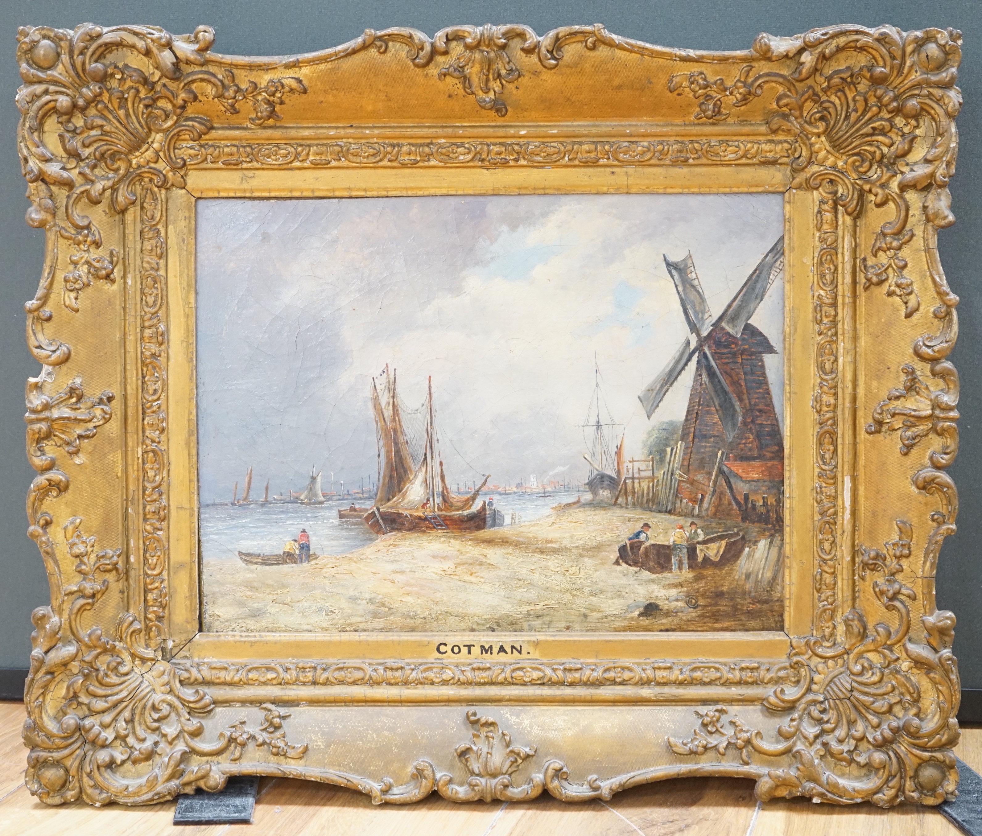 Circle of John Sell Cotman (1782-1842) oil on canvas, Beach scene with moored boats and windmill, inscribed to the frame, 39 x 29cm, ornate gilt frame